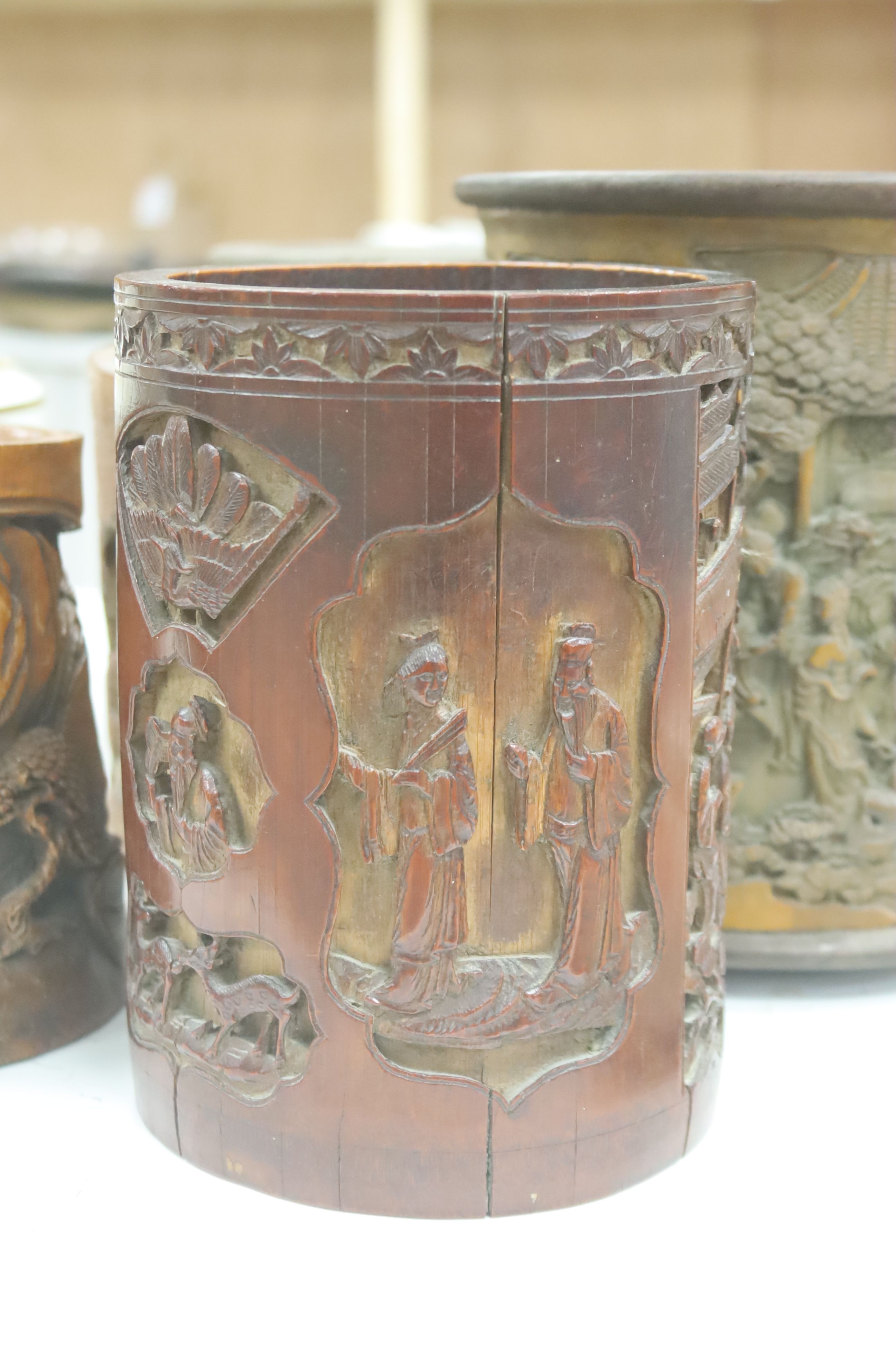 Six 19th/20th century Chinese carved brush pots and a similar carved tea caddy, tallest 20cm